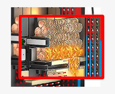 MARELI SYSTEM / CALDAIA LEGNA LCG LAMBDA - L’immagine vuole illustrare il passaggio della fiamma dal vano di carico alla camera di combustione sottostante. È interessante notare che le fiamme, non potendosi sviluppare verso l’alto, non coinvolgono nel ciclo di combustione tutto il carico di legna, ma solo la parte inferiore. I gas che si generano a seguito della pirolisi vengono aspirati, attraverso la feritoia posta alla base del vano di carico, e convogliati nella parte sottostante dove è posta la camera di combustione. Nella zona intermedia della feritoia viene convogliata l’aria comburente secondaria che, miscelata ai gas, ne ottimizza la combustione generando un’enorme quantità di calore con temperature elevatissime che possono raggiungere i 1000÷1100°C. Data l’elevata temperatura raggiunta, nella fase di combustione, la camera di combustione deve necessariamente essere in materiale refrattario ad alta resistenza termomeccanica.